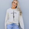 Unshakable Faith graphic sweatshirt for women, featuring a minimalist cross design and inspiring mes.