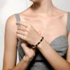 Elegant metal stone hinged bangle on woman's wrist for stylish jewelry.