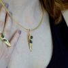 Elegant olive leaf necklace and matching ring in gold with black accents.
