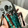 Elegant cutlery set with turquoise handles and stainless steel utensils.